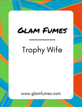 A product image featuring the brand name 'Glam Fumes' and the product name 'Trophy Wife' perfume and body oil in bold, white font against a colorful abstract background.